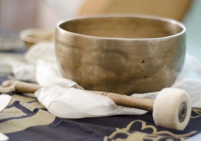 A beautiful hand beaten, Tibetan singing bowl with baton plaed on a white buddhist  scarf.